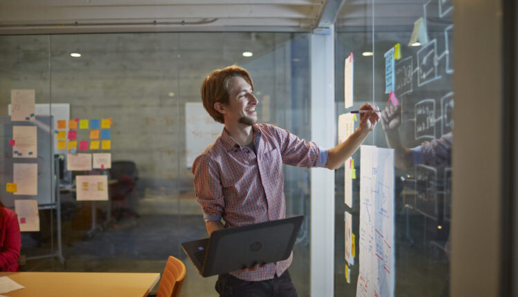 Man holding on HP ZBook 14G2 Mobile Workstation while brainstorm